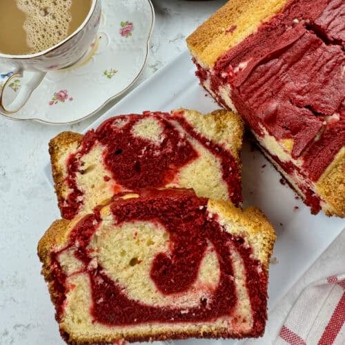 Enjoying red velvet marble pound cake with a steaming cup of coffee with cream.