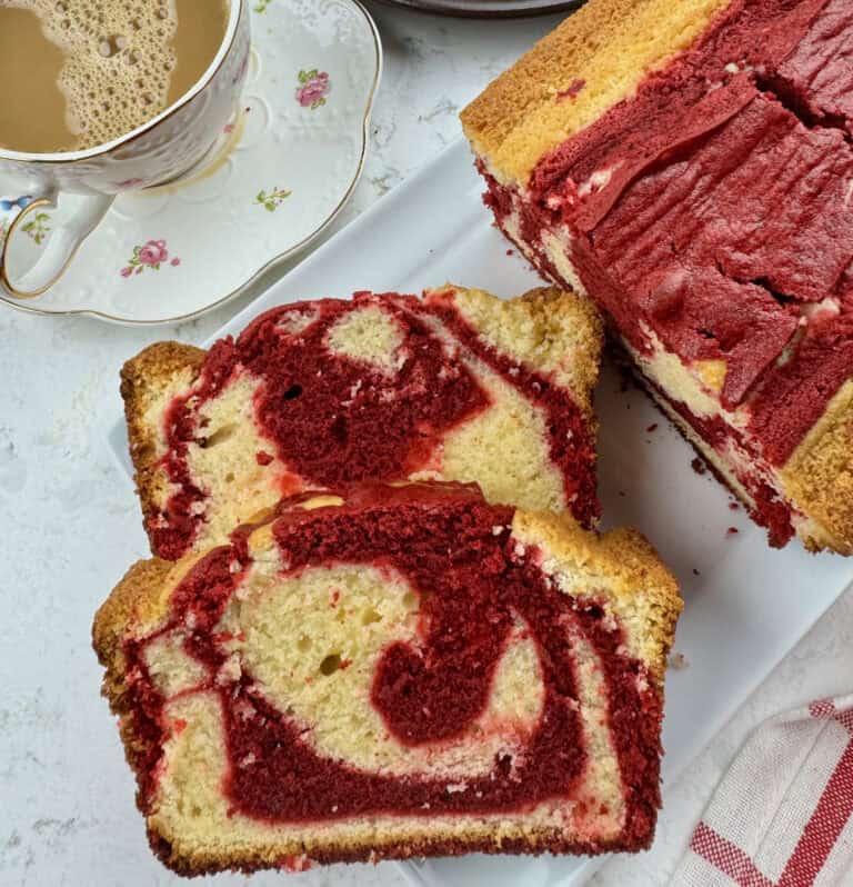 Enjoying red velvet marble pound cake with a steaming cup of coffee with cream.