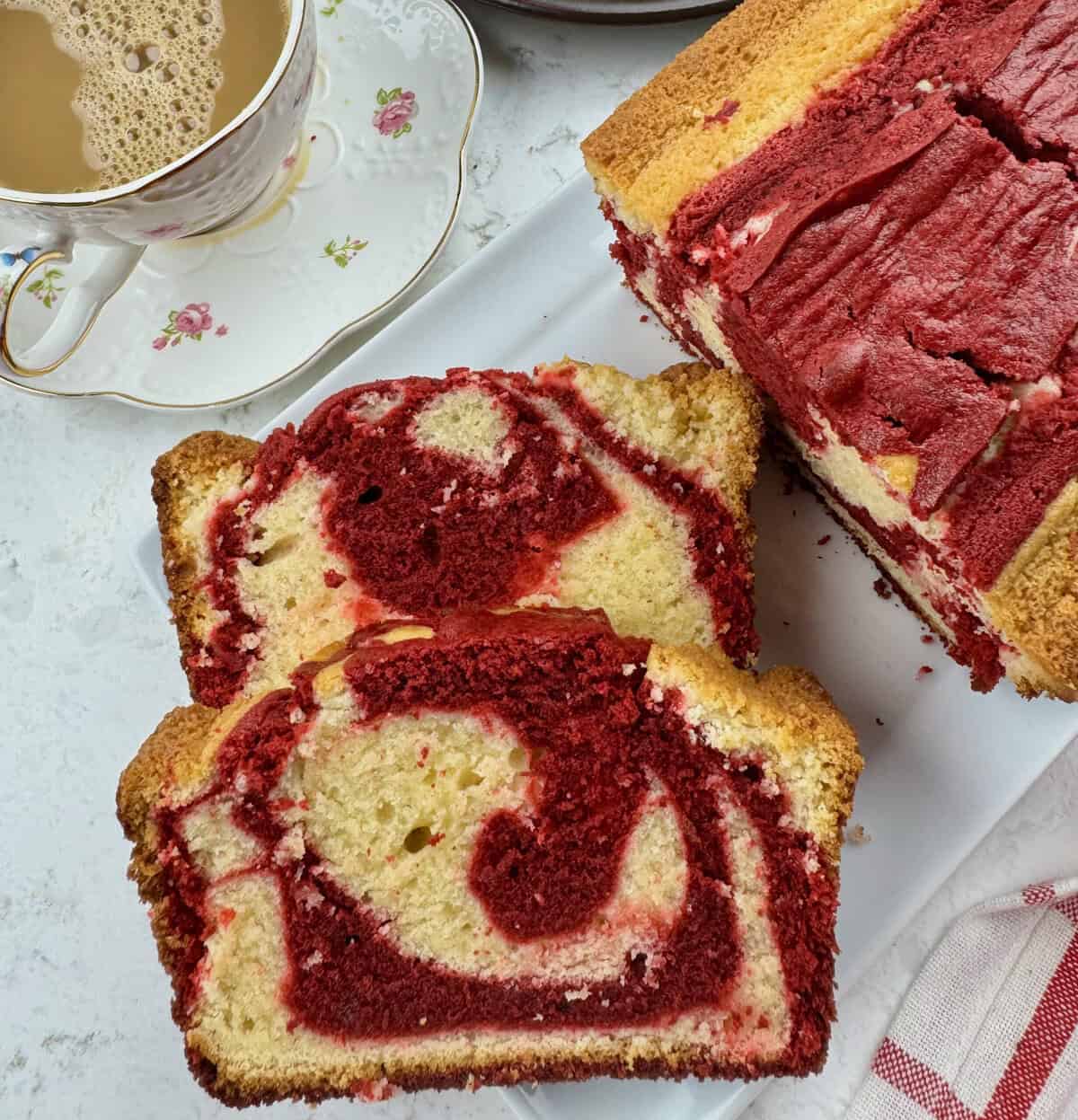 Enjoying red velvet marble pound cake with a steaming cup of coffee with cream.