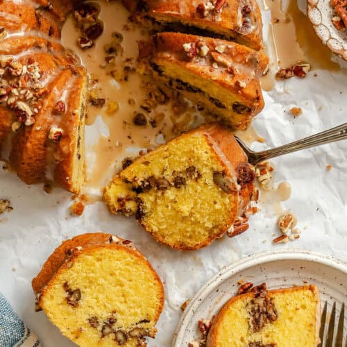 Slicing up and enjoying a buttery cake with pecans.