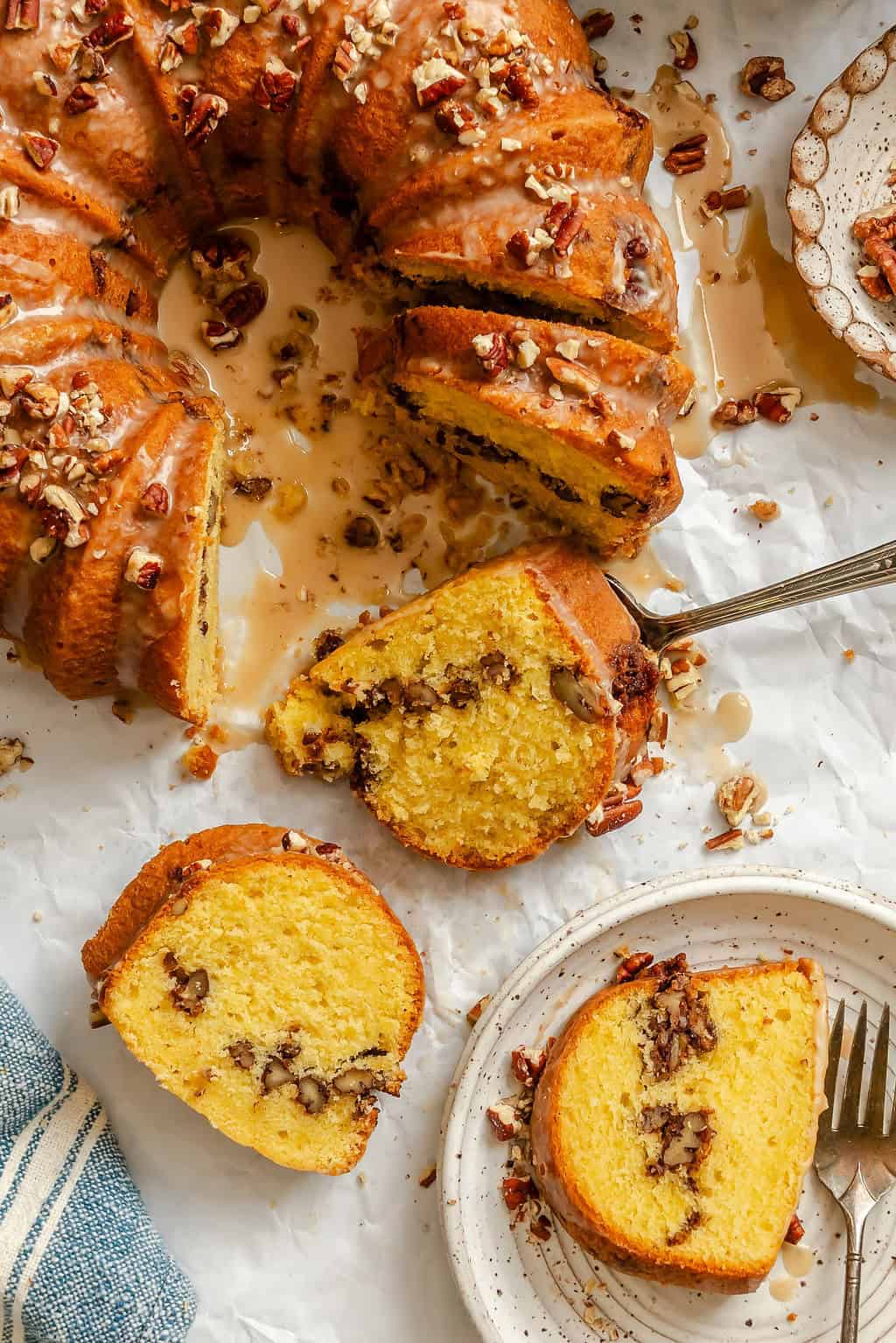 Slicing up and enjoying a buttery cake with pecans.
