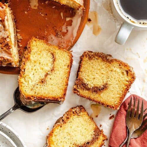 Slicing up and serving a sour cream coffee cake with a steaming hot cup of coffee.