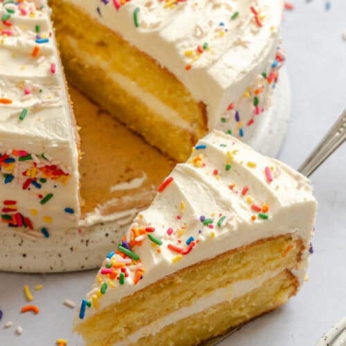 Serving up a slice of vanilla cake decorated for a special occasion.
