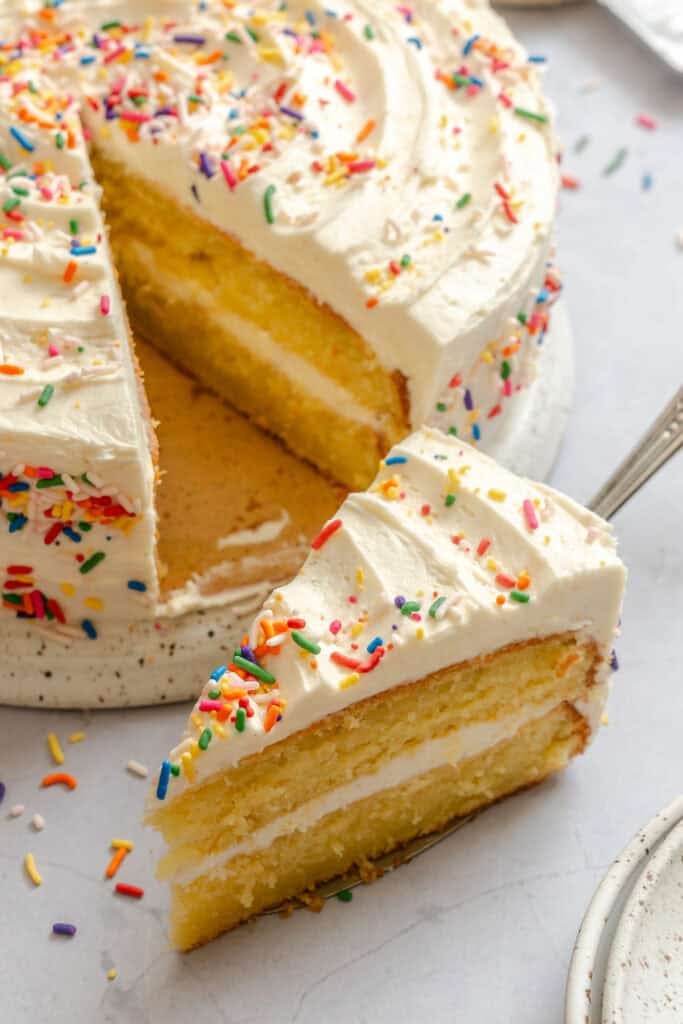 Serving up a slice of vanilla cake decorated for a special occasion.