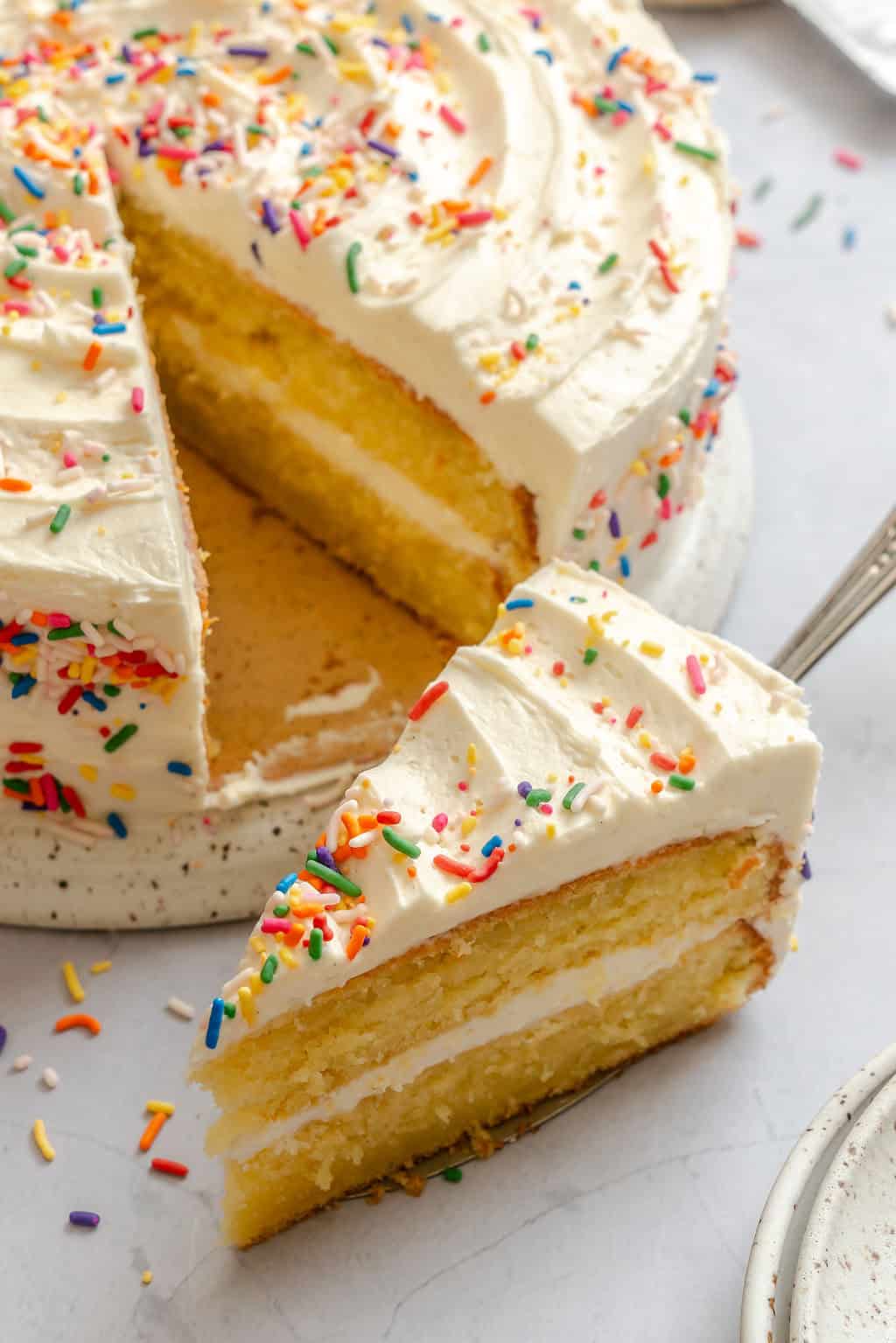 Serving up a slice of vanilla cake decorated for a special occasion.