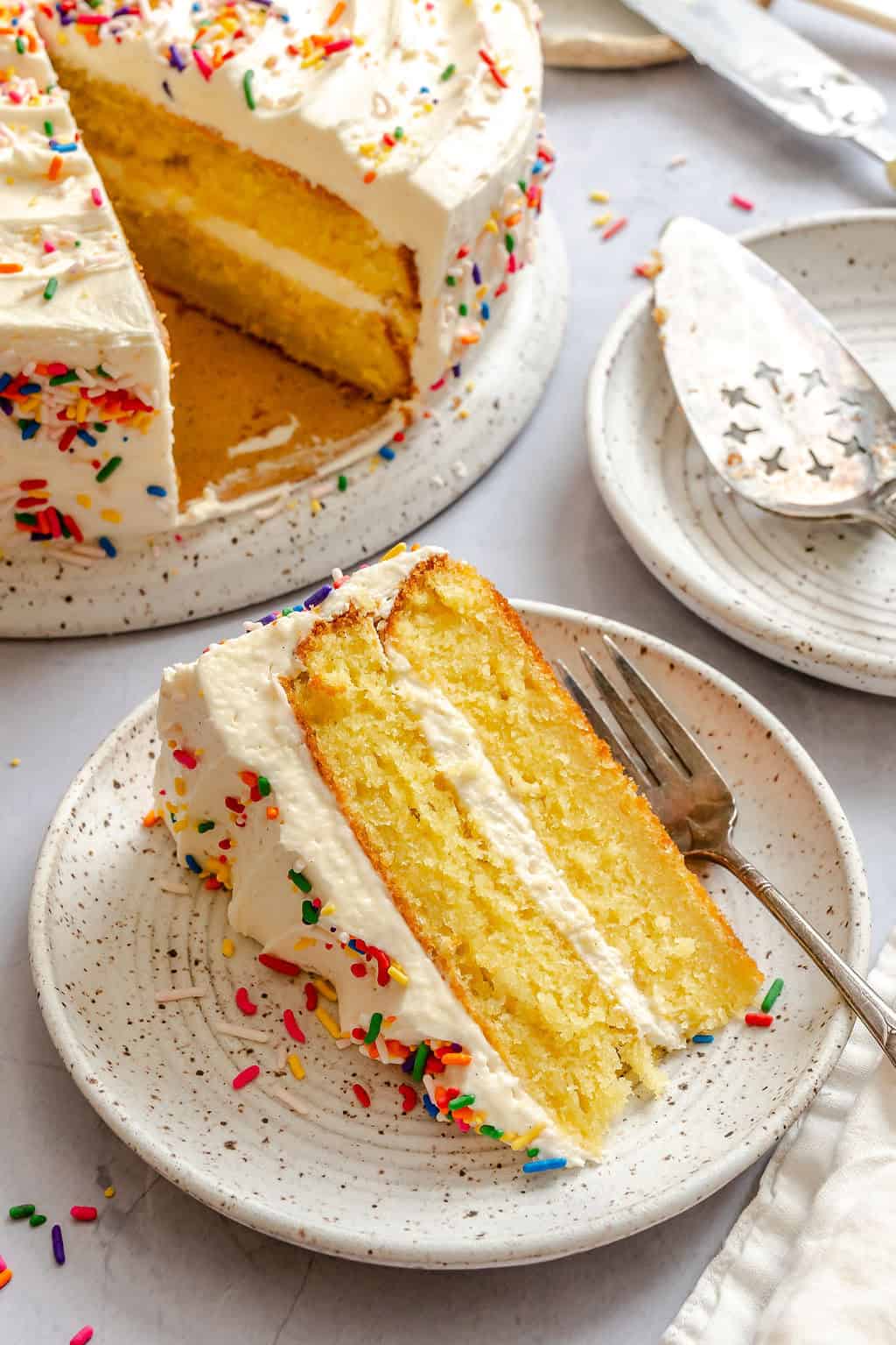 Serving up a slice of cake flavored with vanilla and frosted with and easy butter frosting.