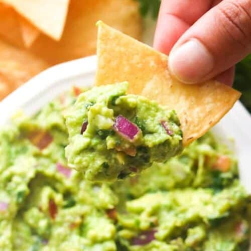 Dipping a tortilla chip into the best guacamole.