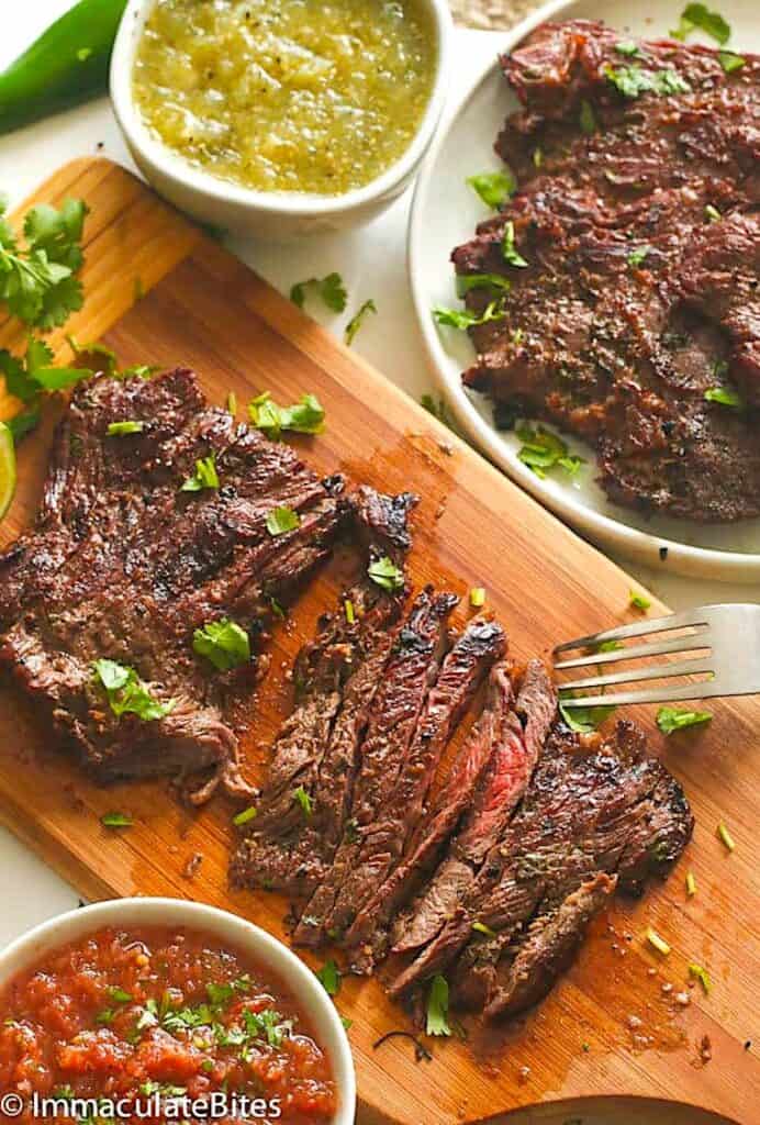 Slicing into marinated grilled skirt steak and serving it with all the right salsas.