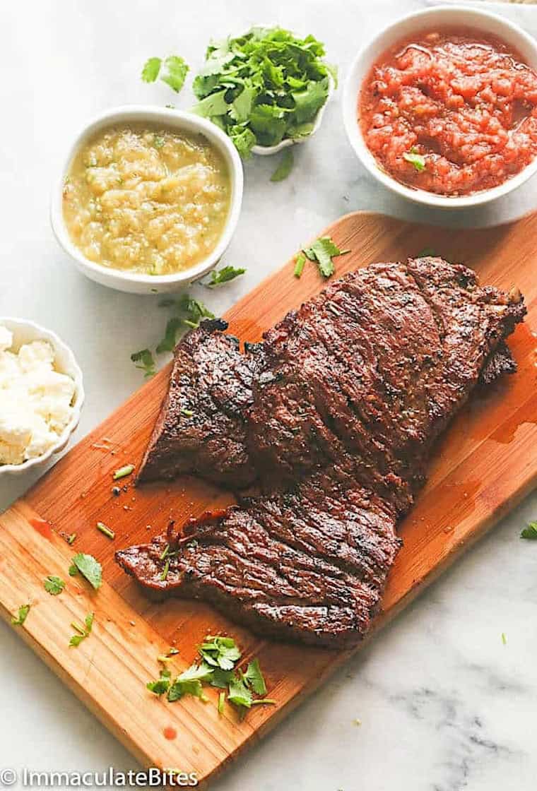 Enjoying marinated grilled skirt steak with salsa verde and traditional salsa.