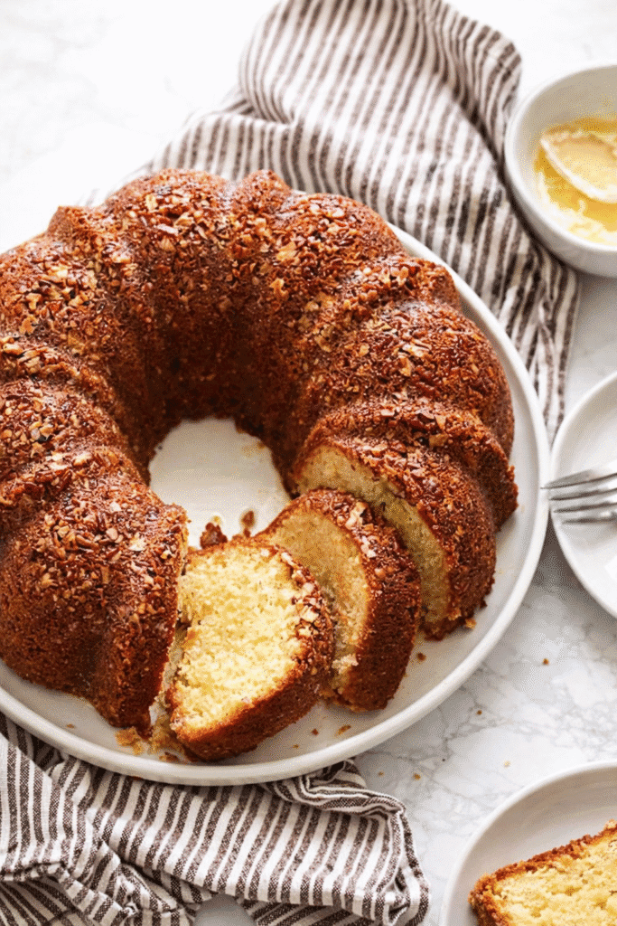 A saucy rum cake, sliced and ready to serve.