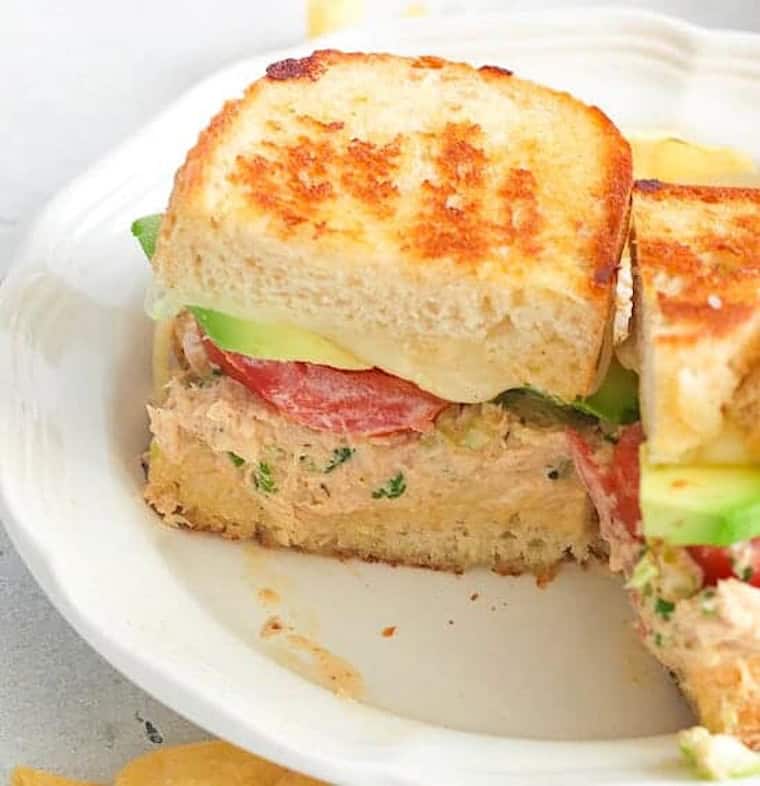Slicing a fresh tuna melt for a satisfying game day snack.