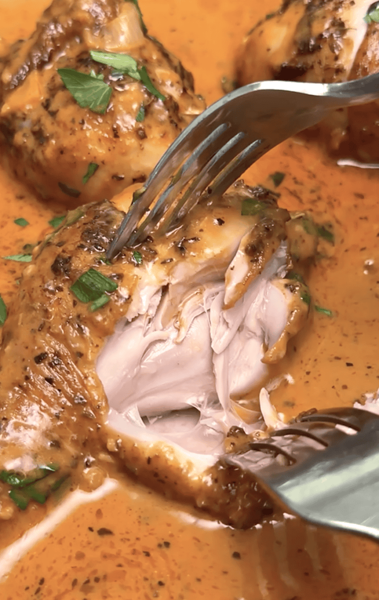 Forking into a juicy, tender chicken leg baked in a decadent cream sauce.