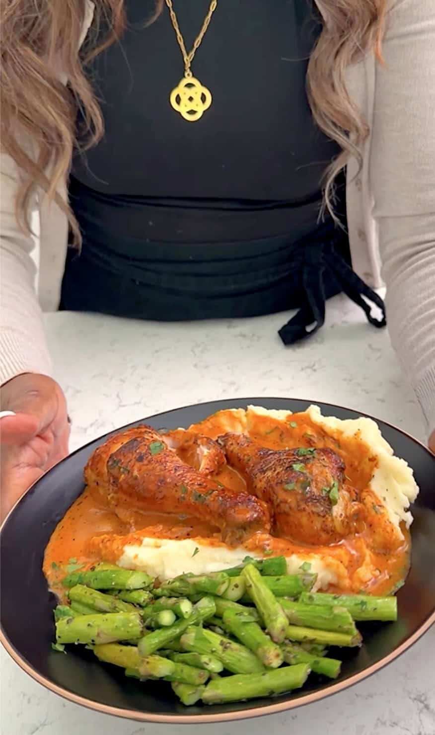 Serving up a plate of creamy baked chicken over mashed potatoes. Green beans are the veggie side.