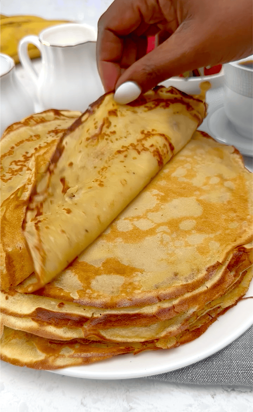 Stacking the pancakes to keep them warm.