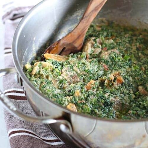 Finishing up pumpkin leaves with meat in a peanut sauce.