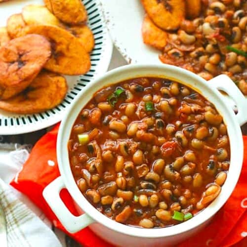 Serving up a pot of red red, African stewed black eyed peas with fried plantains.