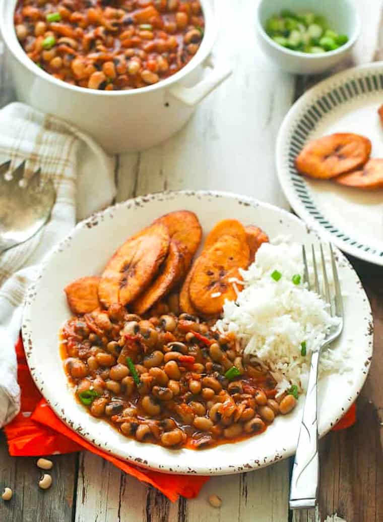 Enjoying red red black-eyed peas with rice and fried plantains.