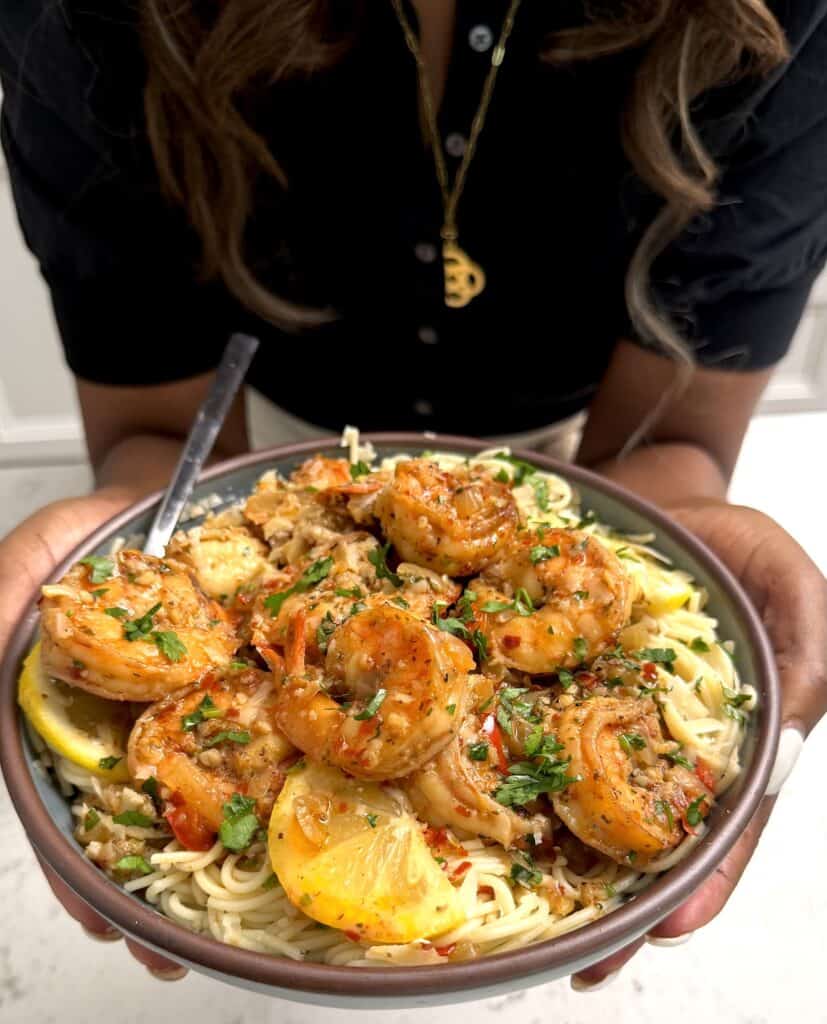 Imma holding up a bowl of homemade shrimp scampi pasta.