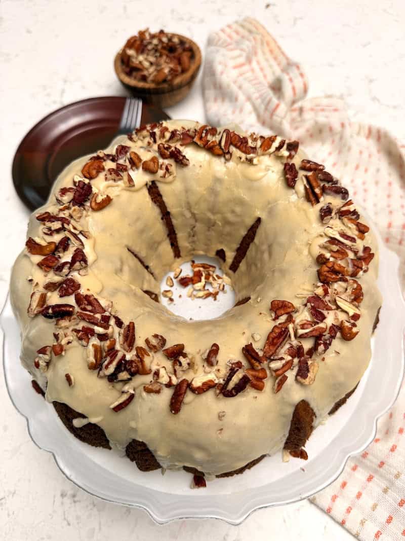 Getting ready to enjoy a freshly frosted sweet potato pound cake topped with toasted pecans.