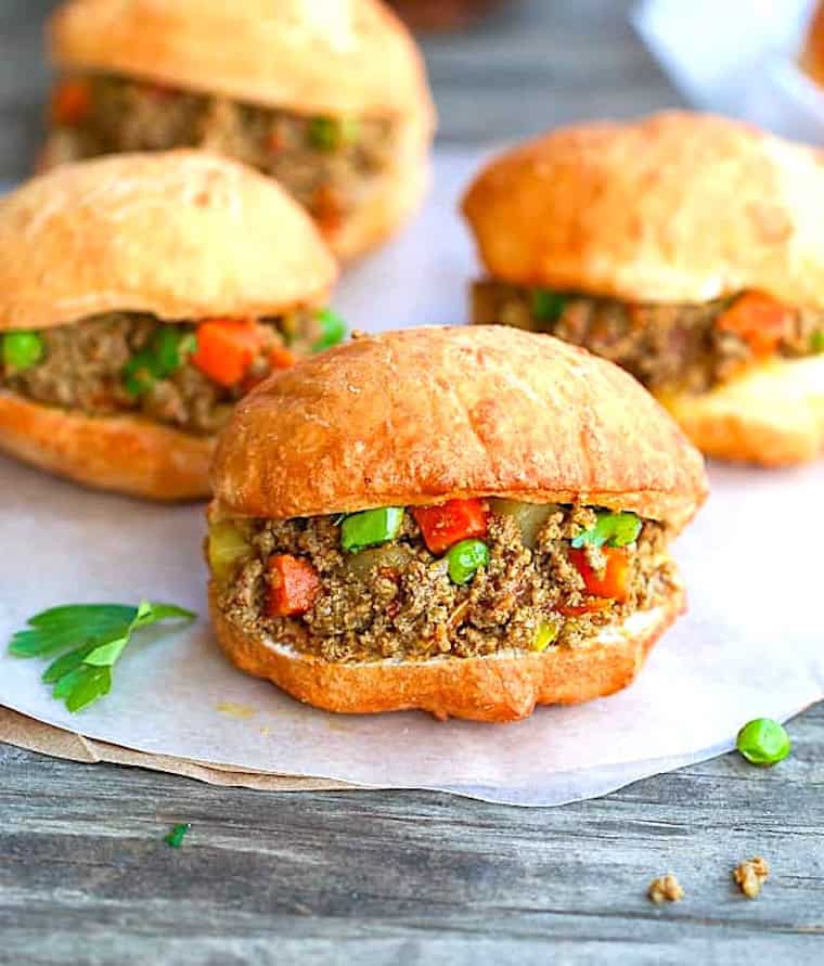 Enjoying fully assembled vetkoeks with the curry filling.