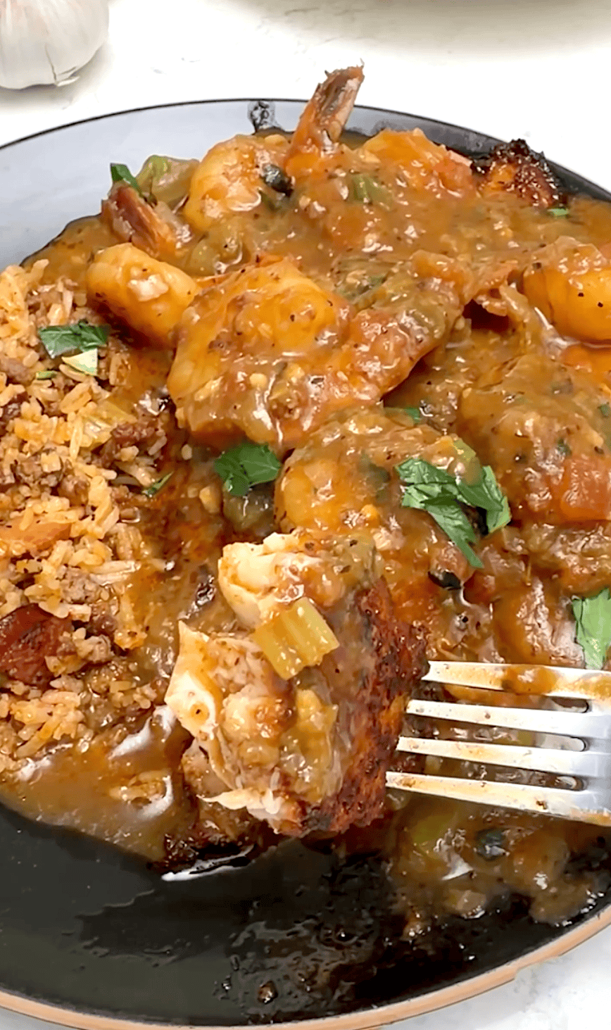 Grabbing a forkful of flaky and tender catfish smothered in shrimp sauce.