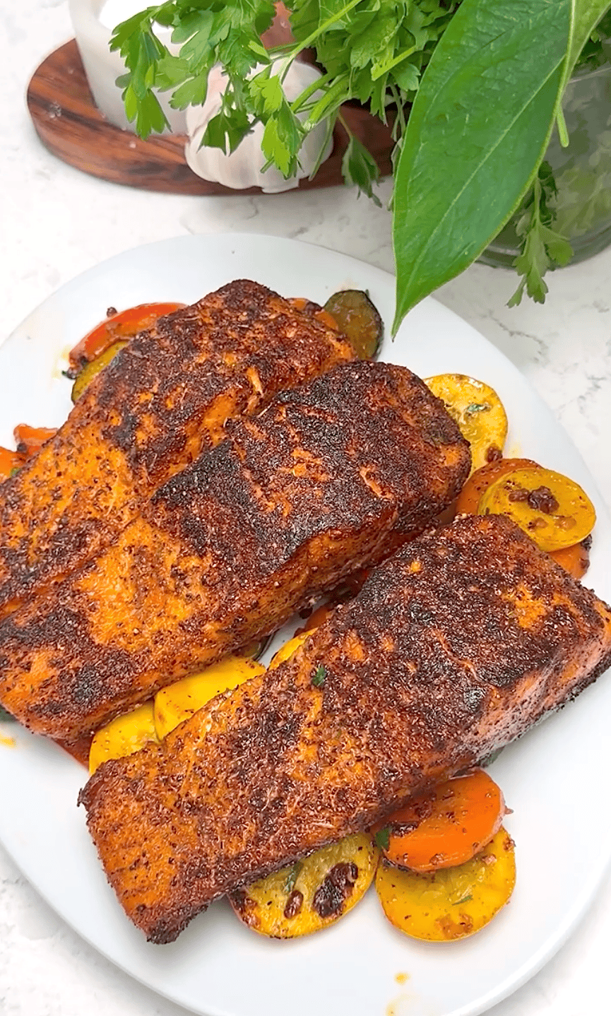 Serving up blackened salmon with spicy vegetables for a hearty, healthy dinner.
