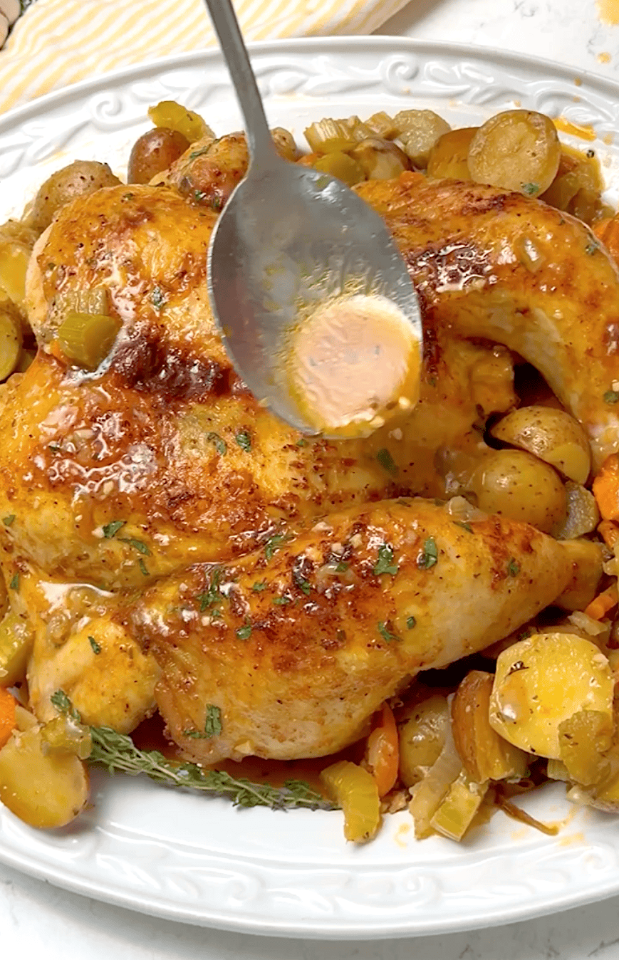 Drizzling pan drippings over blackened-seasoned chicken, spatchcocked for faster roasting.