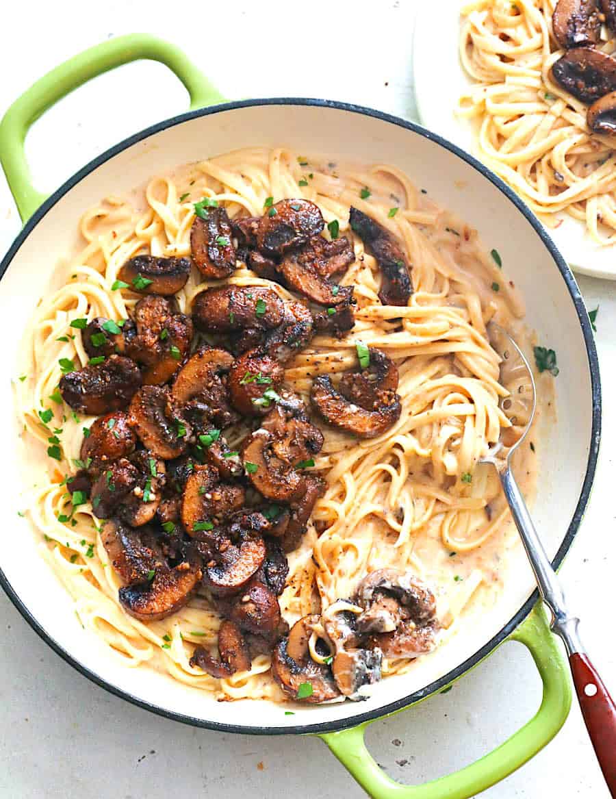 Enjoying freshly made pasta with mushrooms and a cream sauce.