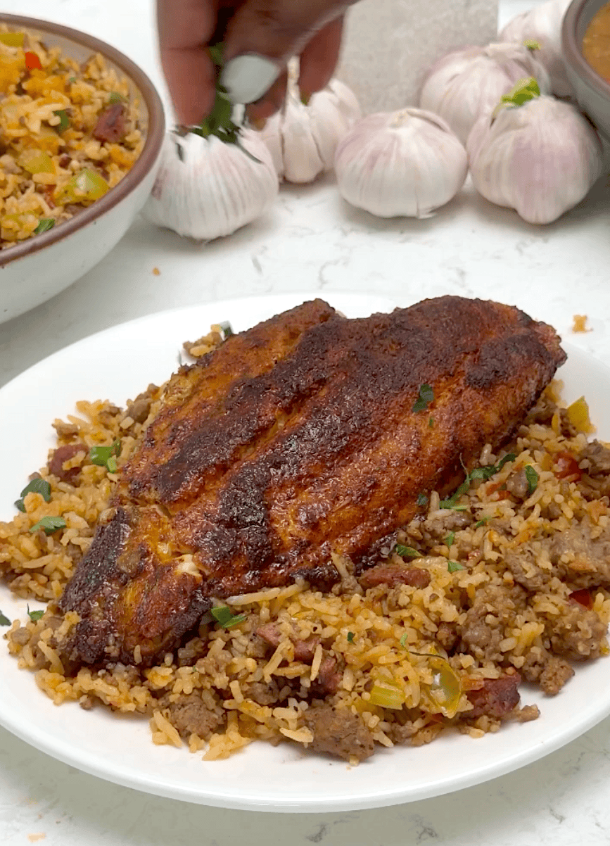 Serving blackened catfish with well seasoned rice.