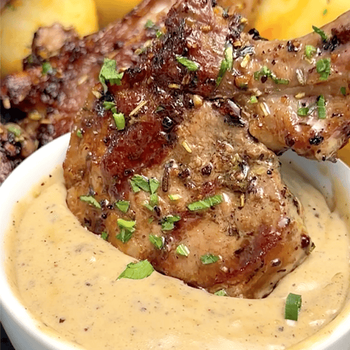 Dipping grilled lamb in a spicy peppercorn sauce.