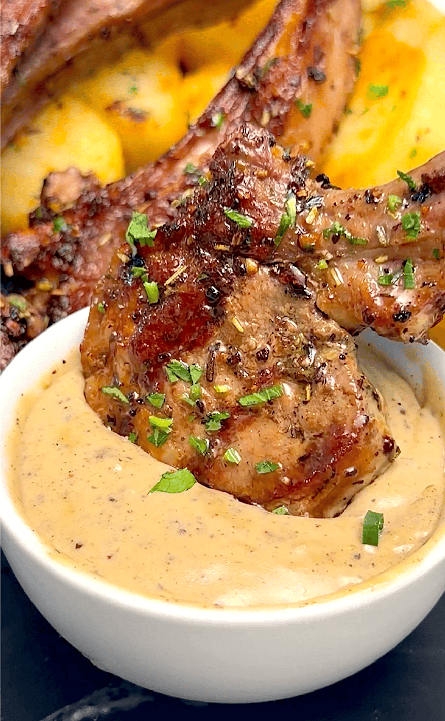 Dipping grilled lamb in a spicy peppercorn sauce.