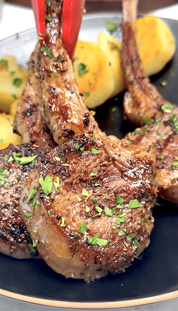 Serving freshly grilled lamb chops with peppercorn sauce.