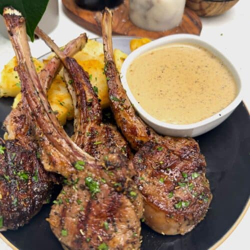 Grilled lamb chops with roasted potatoes and peppercorn sauce for an elegant dinner.