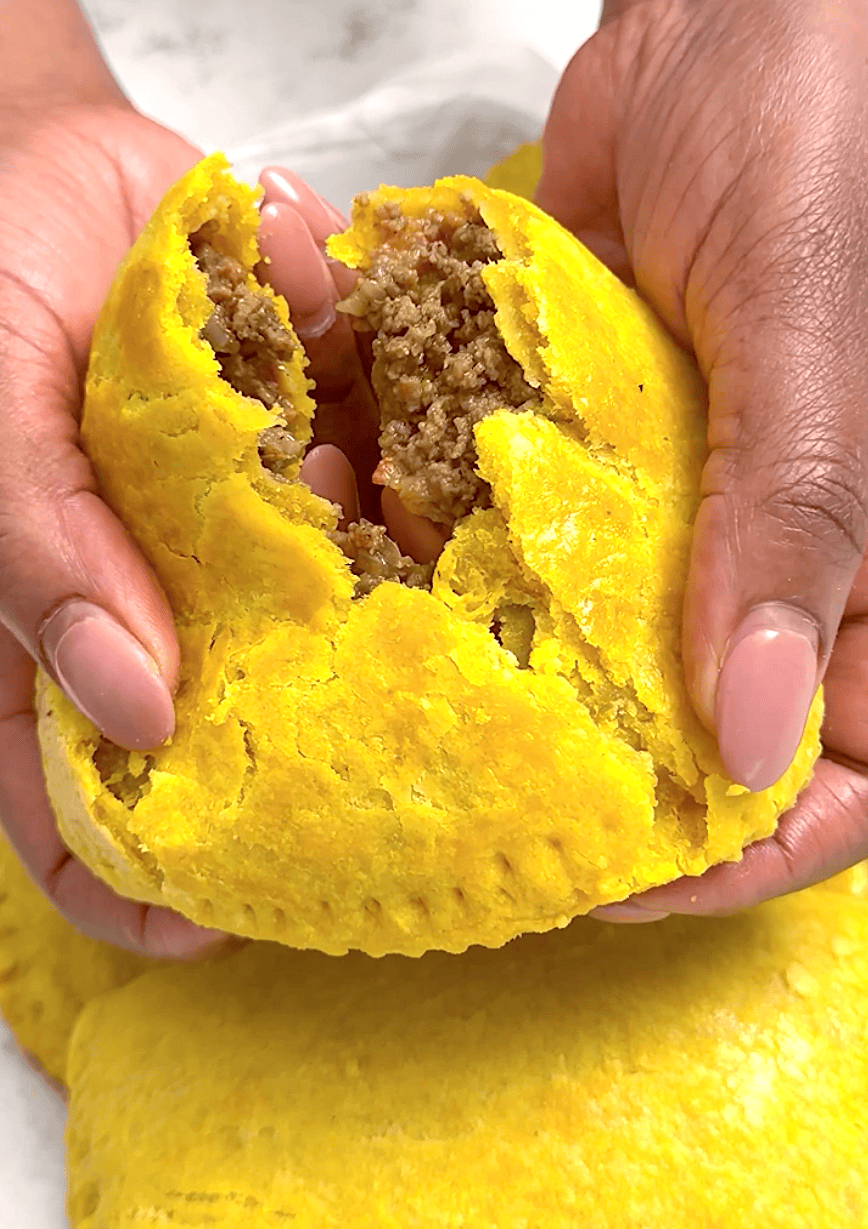 Breaking into a freshly baked meat pie with a buttery, flaky crust.