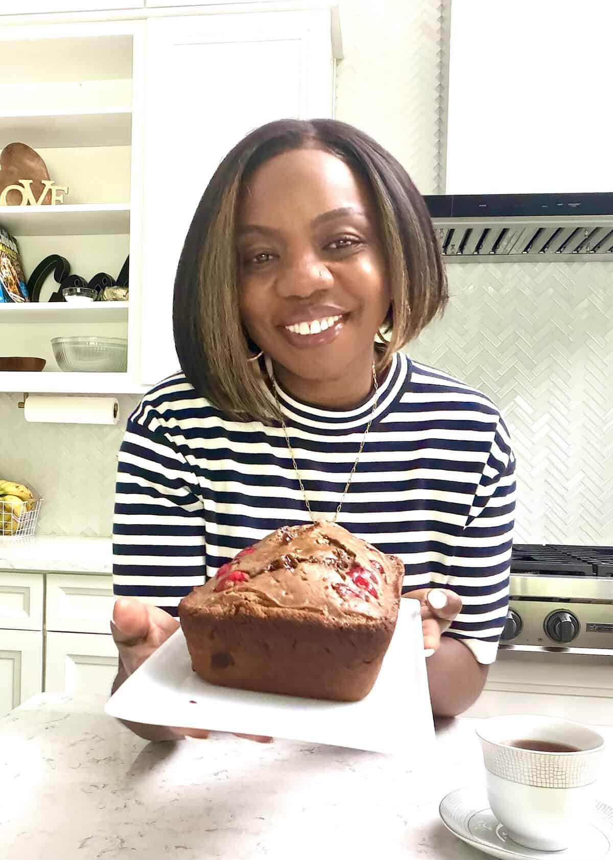 Imma showing off a freshly baked Jamaican Easter spice bun.