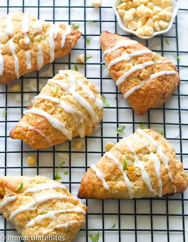 Drizzling glaze on freshly baked scones with pineapple and white chocolate.