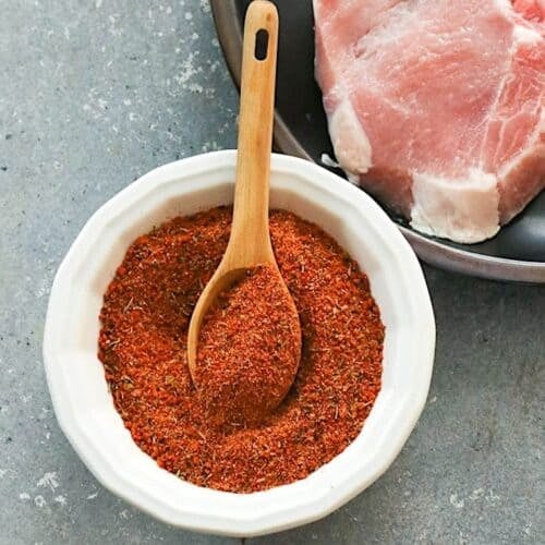 Mixing fresh pork chop seasoning for perfectly seasoned meat.