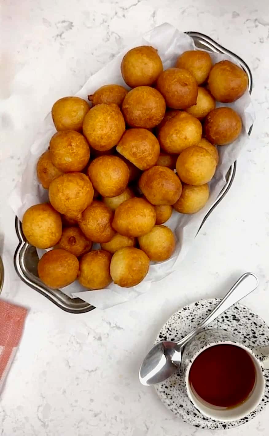Serving up a platter full of freshly fried puff puff.