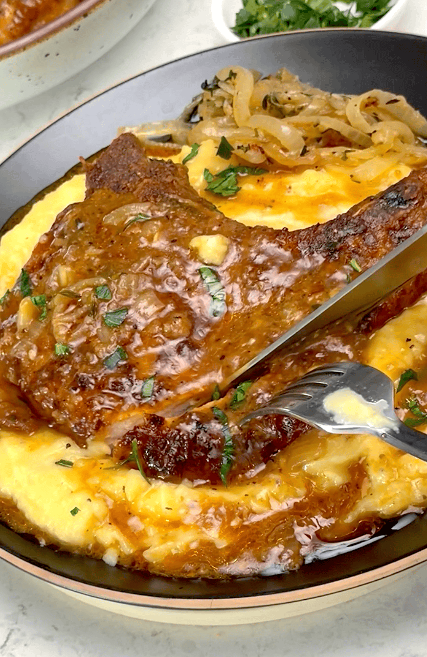 Cutting into a freshly simmered pork chop smothered in gravy.