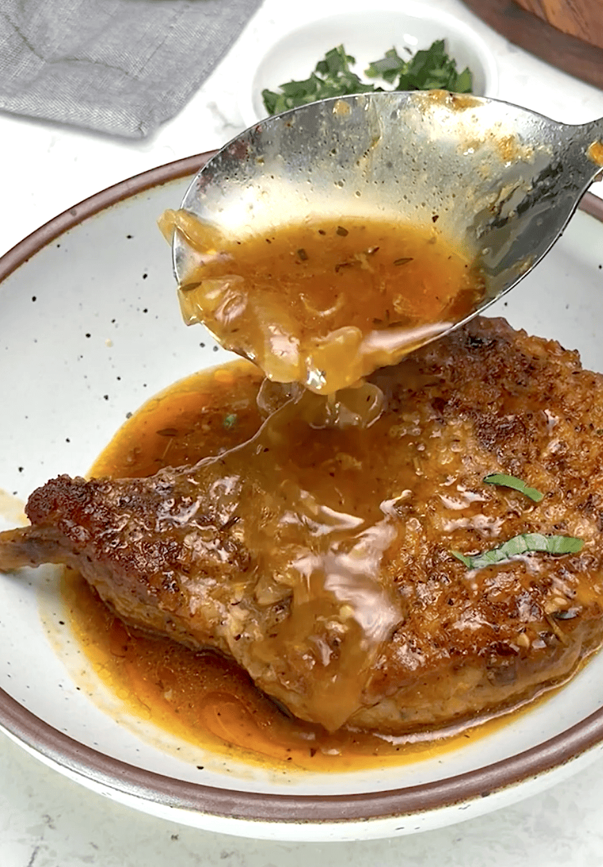 Drizzling tender, juicy pork chops with onion gravy.