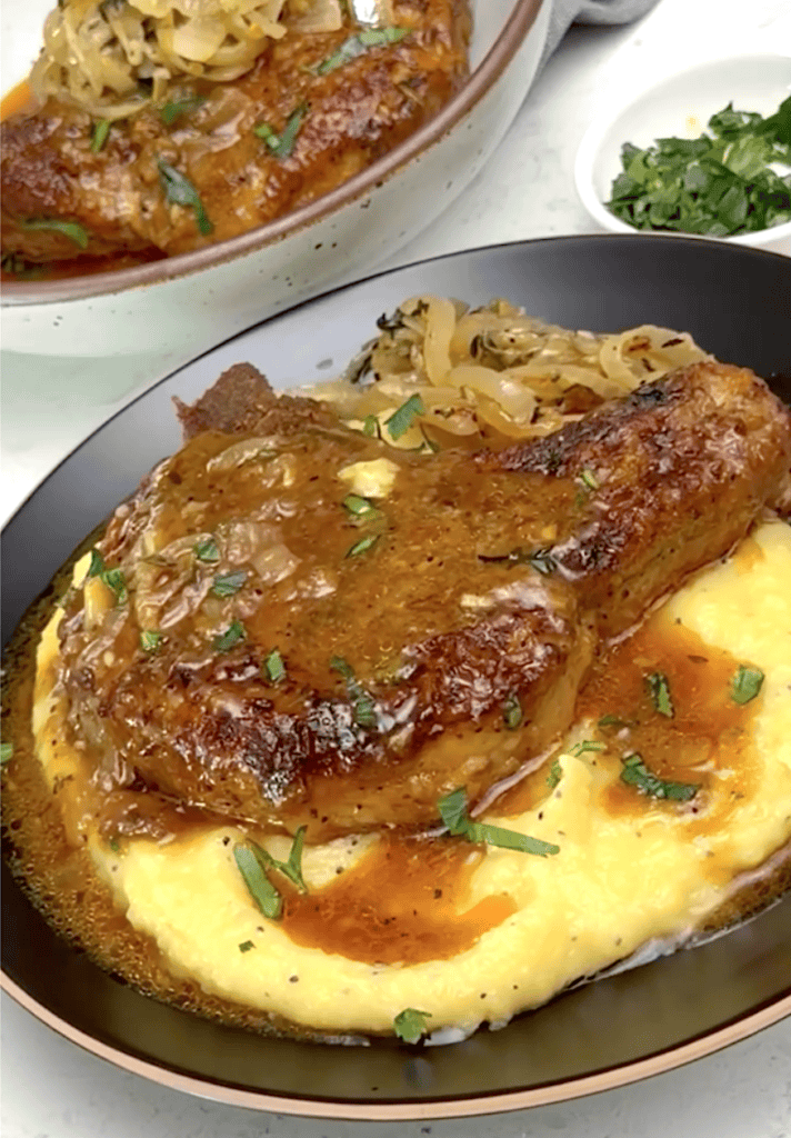 Enjoying smothered pork chops hot off the stove for classic Southern comfort food.