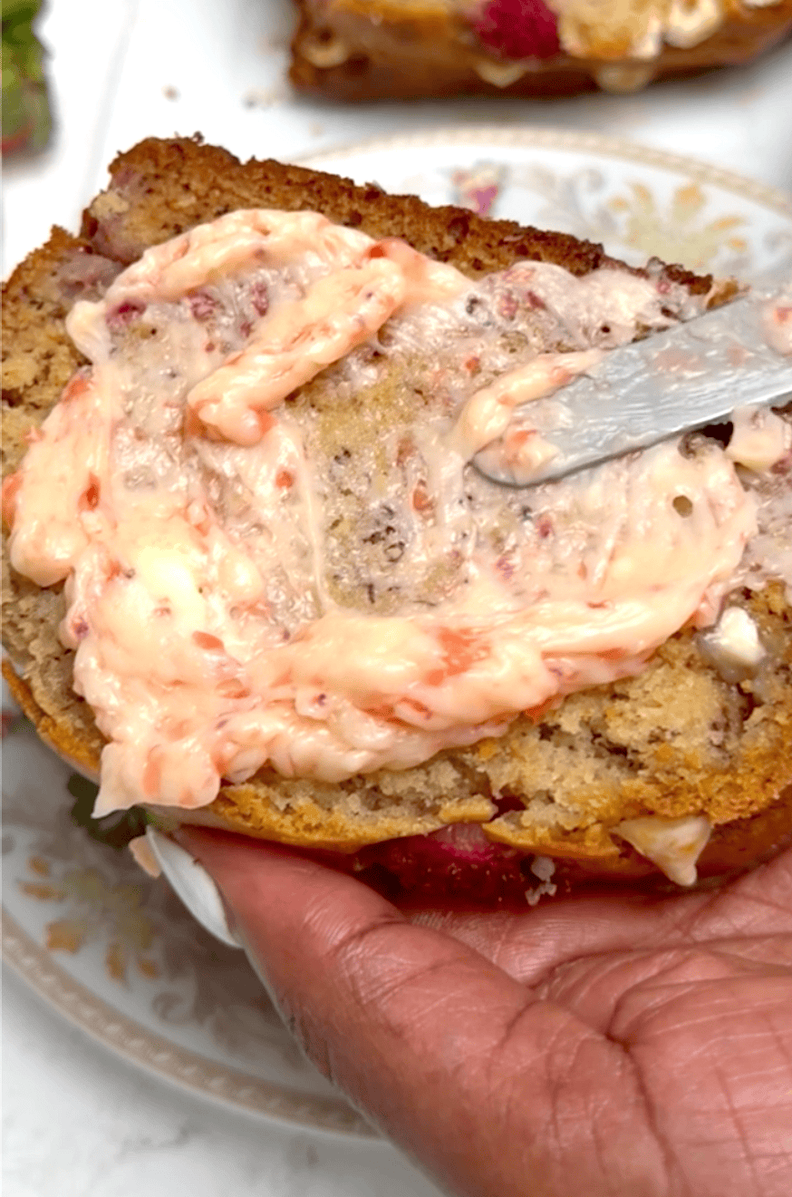 Slathering a slice of freshly made banana bread with strawberry butter.