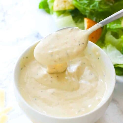 Preparing Caesar salad dressing for a light and healthy lunch side.
