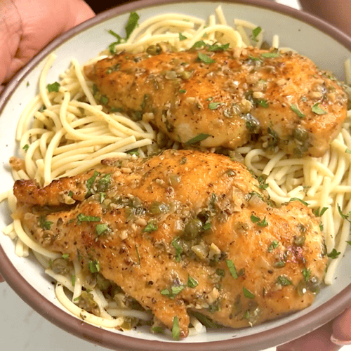 Serving up steaming hot chicken piccata for an elegant dinner option.