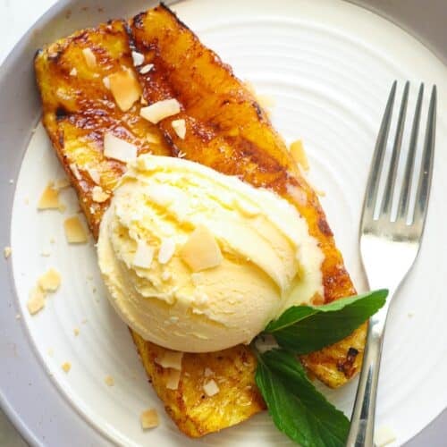 Enjoying vanilla ice cream over pineapple that has been grilled.