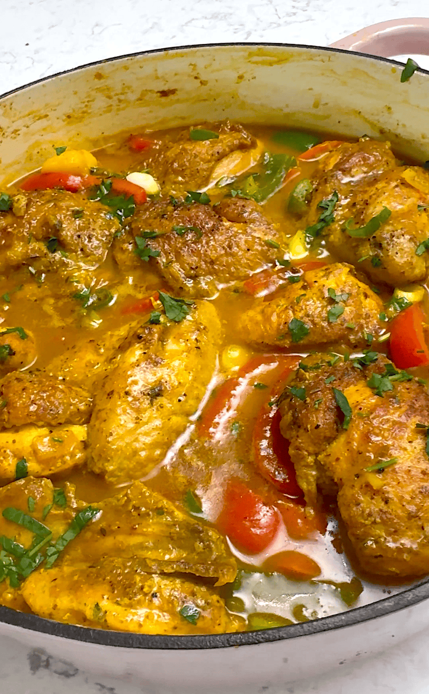 Freshly stewed and steamy hot Jamaican curry chicken ready to serve with rice.