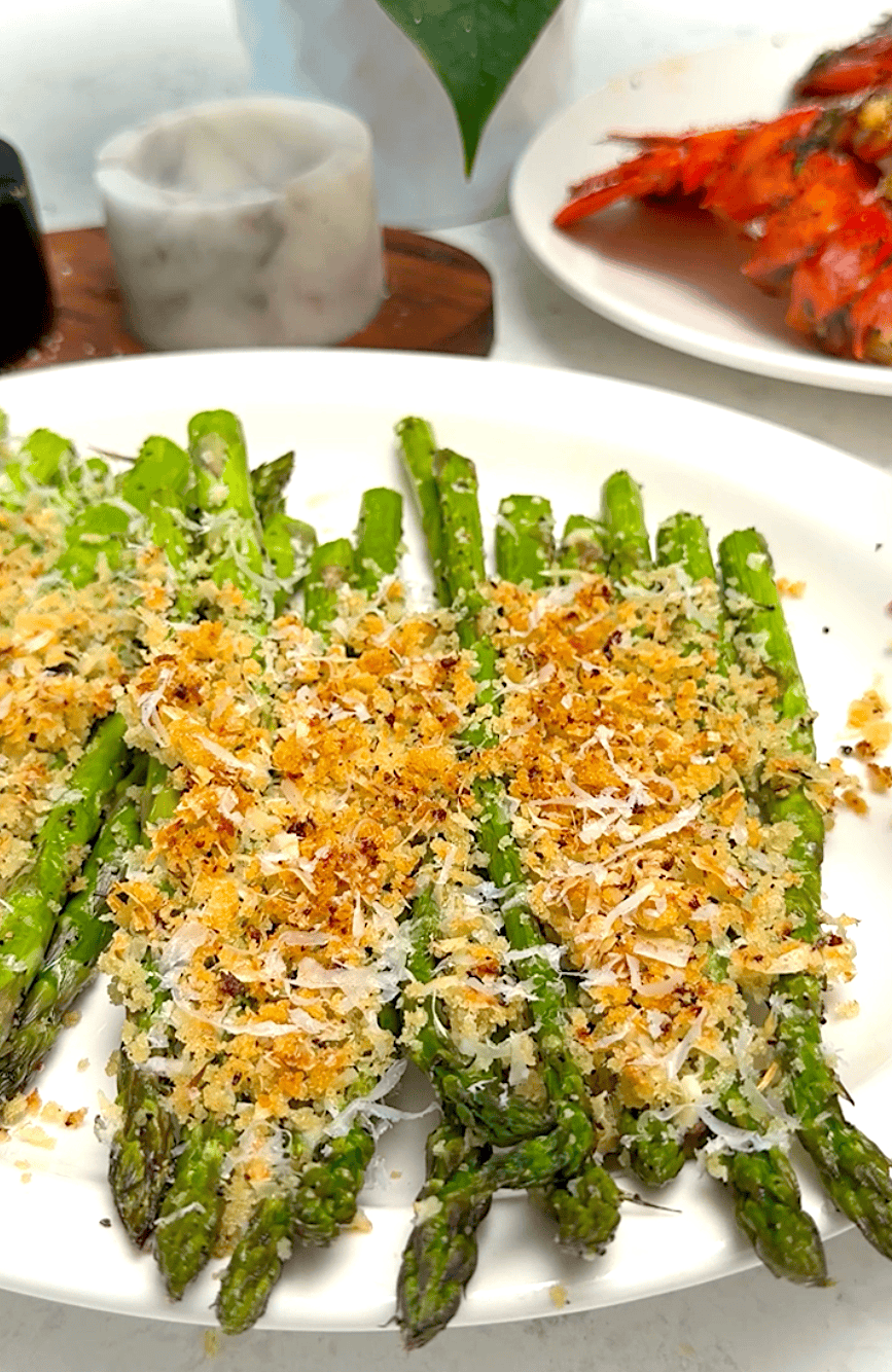 Serving up Parmesan-crusted baked asparagus with broiled lobster tails for an elegant date-night dinner.