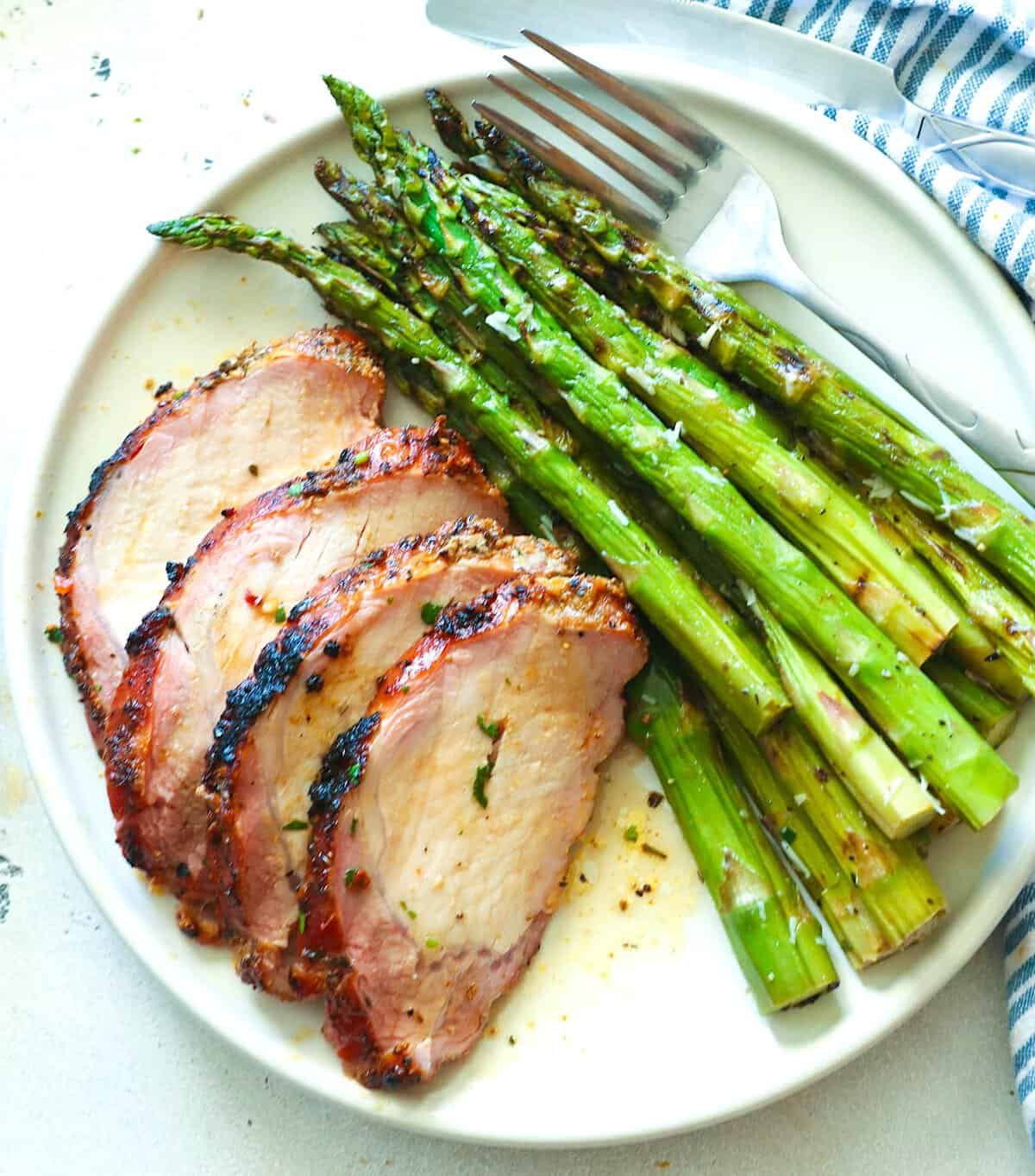 Pork and asparagus, both fresh from the smoker, for a delicious meal.