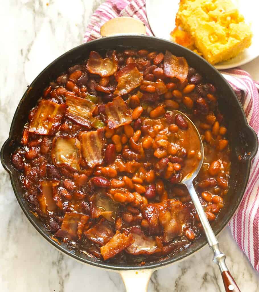 Serving up a skillet full of smoked baked beans for an impressive cookout side.