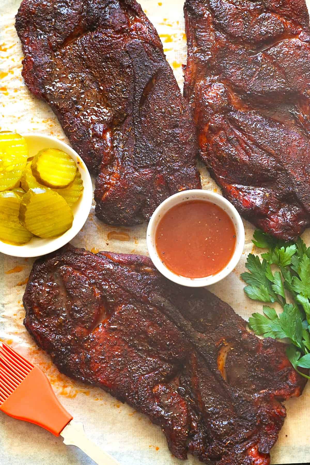 Getting ready to enjoy crowd-pleasing steaks fresh from the smoker with sides perfect for making pork sandwiches.
